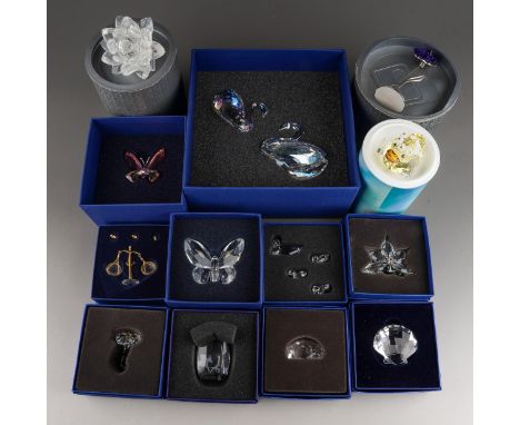 A box of thirteen boxed of Swarovski Crystal, including a two swan set, balance scales and weights, flowers, shell, butterfli