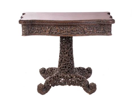 A mid-19th century Anglo-Indian fold-over pedestal card table in the manner of the Ahmerbad Carving Company, with a serpentin