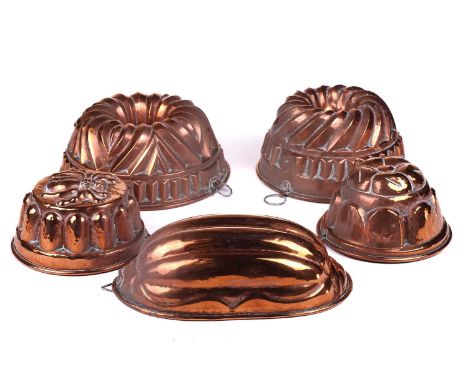 A collection of five probably French 20th-century copper jelly moulds including two circular pipe moulds, 24 cm diameter the 