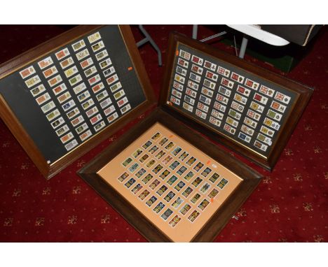 THREE FRAMED AND GLAZED DISPLAYS OF MILITARY CAP BADGES AND KINGS COLOURES, the cards include one frame of cards featuring re