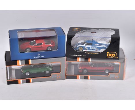 FOUR BOXED IXO MODELS DIECAST MODEL VEHICLES, the first is a 1:43 scale Toyota TS010 CASIO #33 P.H. Raphanel - M. Sekiya - K.