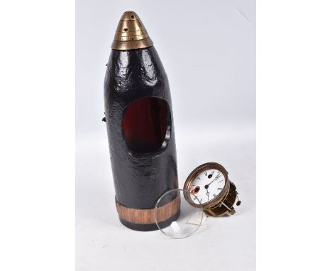 A TRENCH ART MANTLE CLOCK FORMED FROM A BOMB CASING,  19th century movement free from the case, damaged dial, roman numerals,