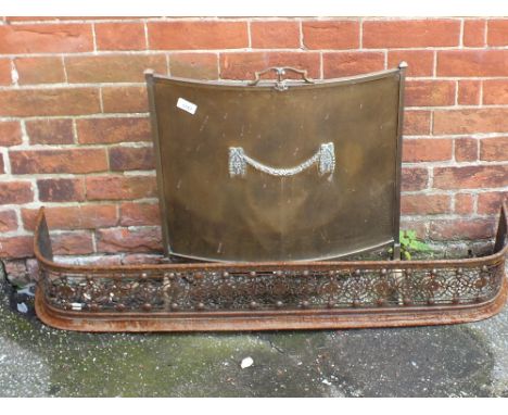 A brass firescreen and an iron fender