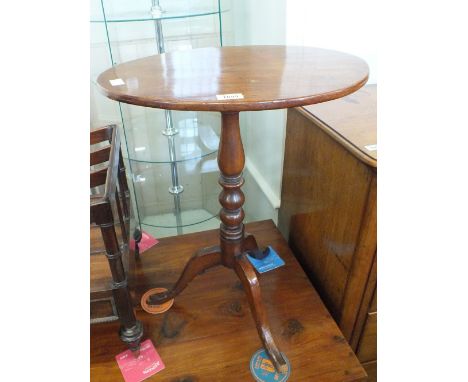 A 19th Century oval mahogany snap top table on turned column and tripod support