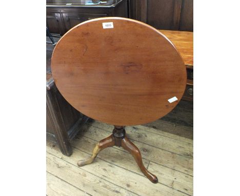 A Victorian circular mahogany snap top table on turned column and tripod supports