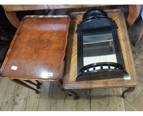 A nest of three walnut occasional table, an ebonised mirror back wall shelf and a brass banded and cross banded table