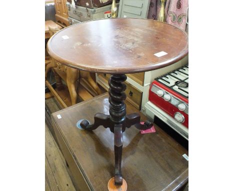 A Victorian circular table on barley twist column and tripod support