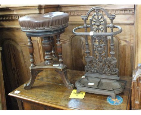 A Victorian leather top mahogany piano stool and a cast iron stick stand