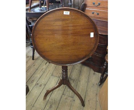 A Victorian circular mahogany snap top table on turned column and tripod supports