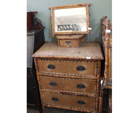 A vintage bamboo chest of three drawers, a bamboo magazine rack, a bamboo mirror and a bamboo hanging cabinet