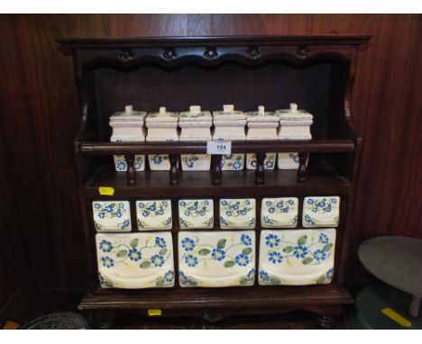 A VINTAGE MAHOGANY HANGING SHELF WITH INSET CERAMIC JARS