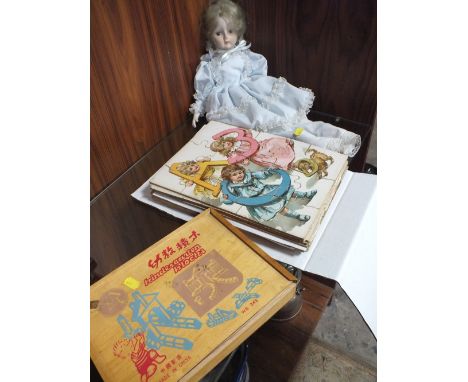 A SET OF CHINESE WOODEN BUILDING BLOCKS TOGETHER WITH VINTAGE JIGSAW PUZZLES AND A PORCELAIN HEADED DOLL