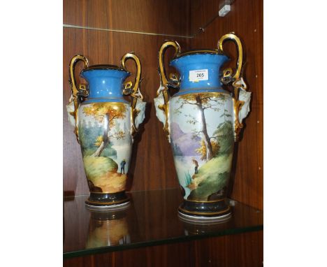 A PAIR OF HAND PAINTED VINTAGE CERAMIC TWIN HANDLED VASES