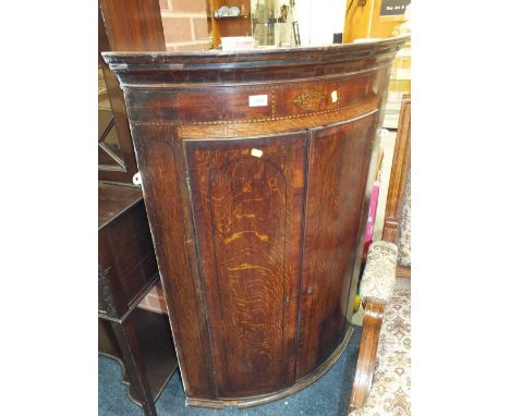 A 19TH CENTURY OAK AND INLAID BOW FRONTED HANGING CORNER CUPBOARD, H 115 cm,. W 79 cm