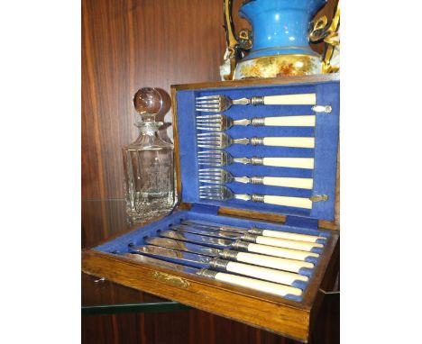 A CASED SET OF FISH KNIVES &amp; FORKS TOGETHER WITH A DECANTER