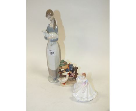 A LLADRO FIGURE OF A LADY WITH A LAMB TOGETHER WITH A SMALL ROYAL DOULTON FIGURE AND A GOEBEL EXAMPLE