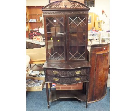 AN ANTIQUE MAHOGANY DISPLAY CABINET OF SMALL PROPORTIONS, in the Chippendale style, having twin glazed doors to the upper sec