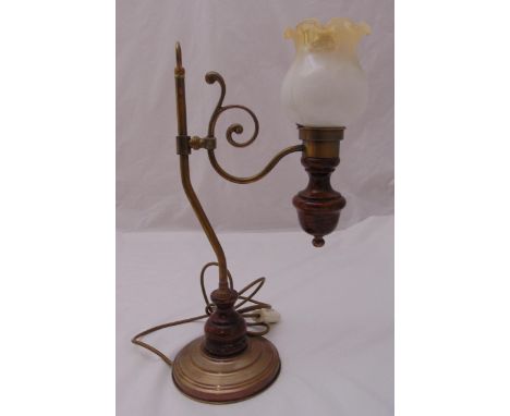 A Victorian style brass and wooden table lamp, the scrolling arm supporting a lamp with fluted frosted glass shade on raised 