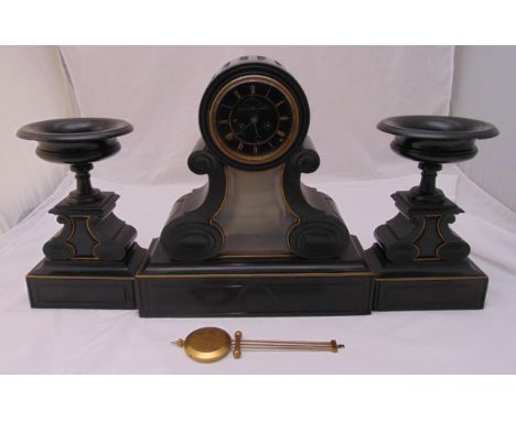 A late Victorian black slate mantle clock of architectural form flanked by two urn form garnitures,  to include pendulum, 49c