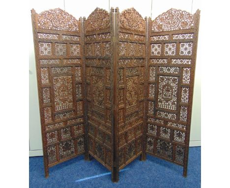An oriental four panel wooden carved and pierced screen, each panel 173 x 52 x 2cm
