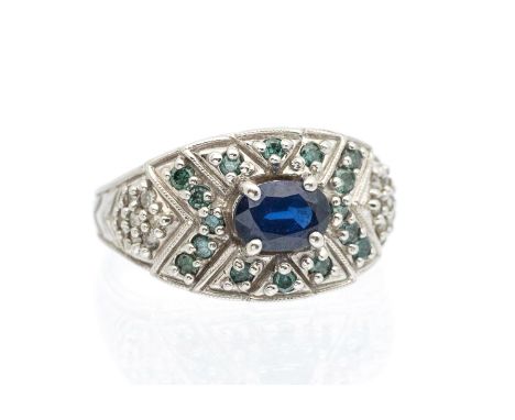 A sapphire and blue diamond set 14ct white gold ring, comprising a central oval mixed cut sapphire, approx 7 x 5mm, within a 