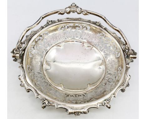 A Victorian silver basket, having pierced and engraved decoration with folding handle, with engraved inscription to base dati