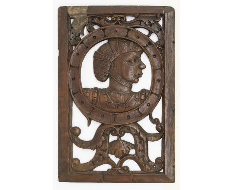 A 16th century carved oak rectangular portrait panel, with a central carved section depicting portrait of a young gentlemen i