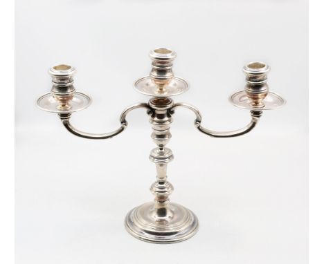 An Elizabeth II silver three branch candelabra, consisting of single candlestick with knopped stem and circular footed base, 