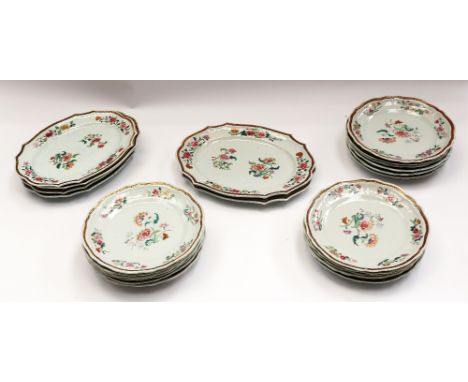 An 18th Century Chinese Export famille rose part scalloped dinner service, decorated with various floral sprays within scroll