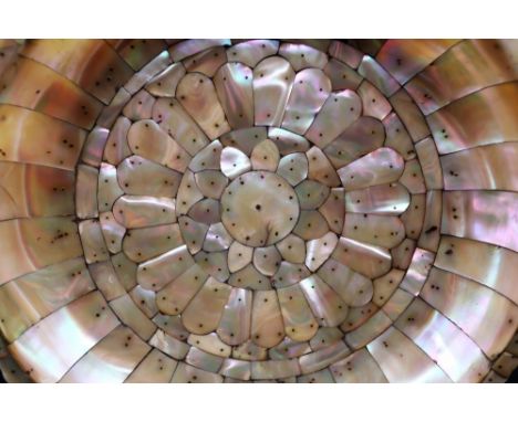 An Indo-Portuguese mother of pearl dish, Gujarat, 16th/17th century, the frame of bracketed rim panels enclosing a radiated a