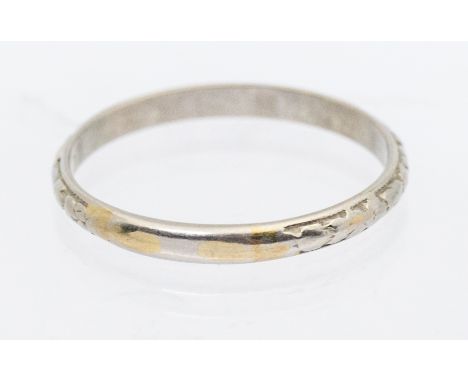 A narrow platinum ring with textured decoration, width approx 2mm, size R, weight approx 2.4gms  Further details: wear commen