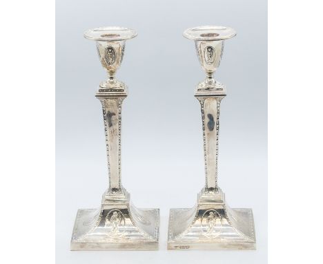 A pair of Edwardian Neo-Classical silver candlesticks, hallmarked by Hawksworth, Eyre & Co Ltd, Sheffield 1904, approx 29.5 c