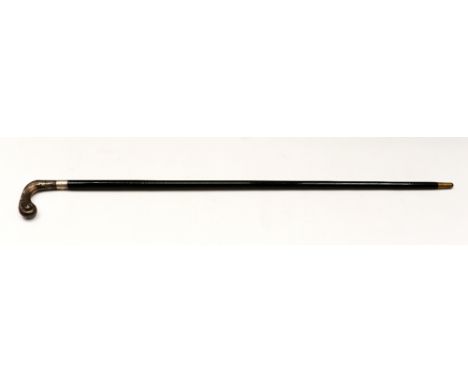 A 20th century ebonised wooden walking stick, having stylised silver handle, of scrolled shape with foliate cast detail and t