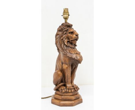 A late 20th / early 21st century carved oak lamp base in the form of a Lion, on octagonal weighted base, with cable going thr