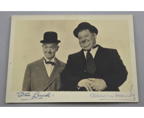 Stan Laurel & Oliver Hardy, English & American comedy double act, a vintage signed b&w photograph of Laurel & Hardy, signed i