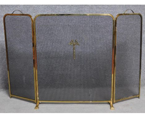 A Regency style brass fireguard with ribbon motif to the centre. 83x133cm 