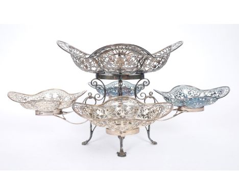 Edwardian silver epergne. An Edwardian silver table centrepiece, the scrolling two-tier armature supporting a large, pierced,