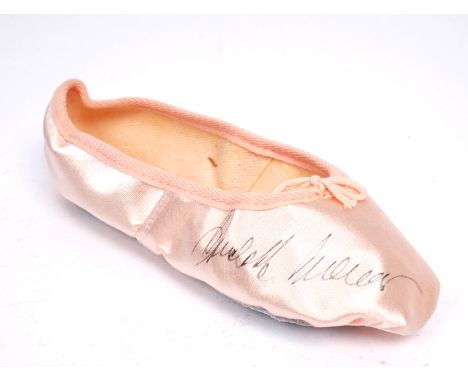 Rudolf Nureyev, signed ballet slipper A pink satin ballet slipper signed in black pen by Rudolf Nureyev at the after-show din