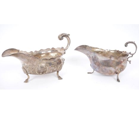 18th and 19th century silver sauce boats. A George III silver, helmet-shaped sauce boat, the wavy rim and s-scroll handle on 
