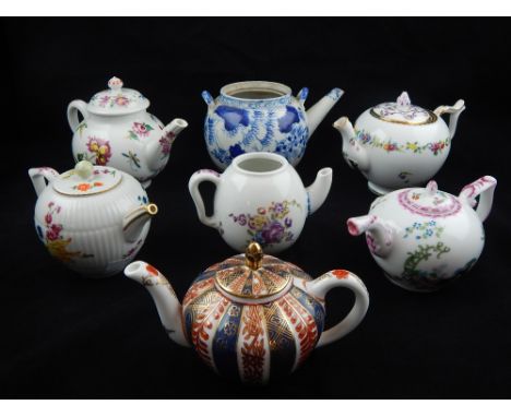 Six Victoria & Albert edition reproduction porcelain tea pots and a Chinese blue and white teapot. (7)