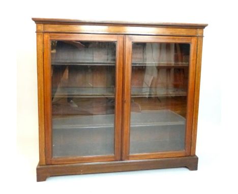 Edwardian inlaid mahogany dwarf bookcase, satinwood crossbanding, shelves enclosed by a pair of glazed doors, bracket feet, 1