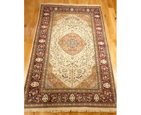 Wool carpet, floral central stepped medallion and traditional Tabriz design, over cream and marron ground, fringed, 214x140