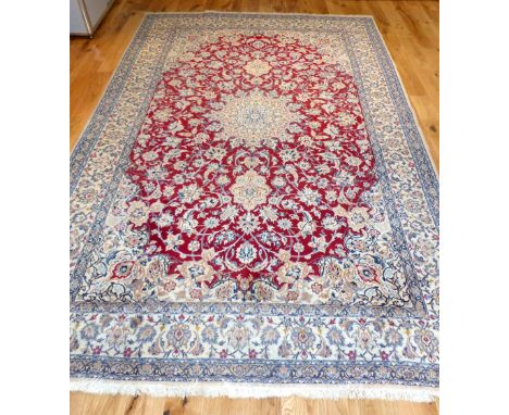 Persian Nain carpet, traditional floral design over red and cream ground, fringed,  316x205cm