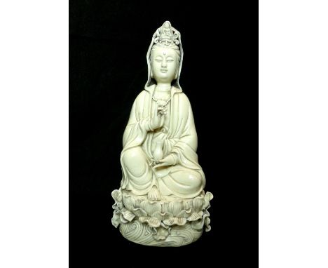 Chinese statue, study of Guan Yin, Buddhist goddess of compassion, holding a vase and peach stone, seated upon lily pad, impr