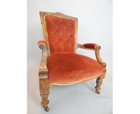 Late 19th century Continental elbow chair, walnut, leaf carving, bow apron, turned legs, ceramic castors, later buttonback up