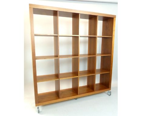 Modern walnut 4 x 4 shelf unit, raised on casters, 174cm h, 162cm w