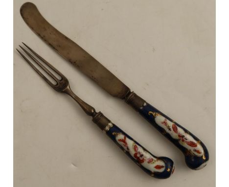 An 18th century Worcester pistol grip knife and fork, the handles having a scale blue ground decorated with reserve panels of