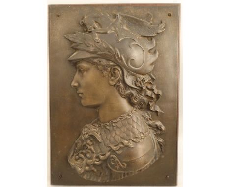 A metal plaque, relief decorated with a portrait of a figure wearing armor decorated with dragons, on a wooden back, 20ins x 