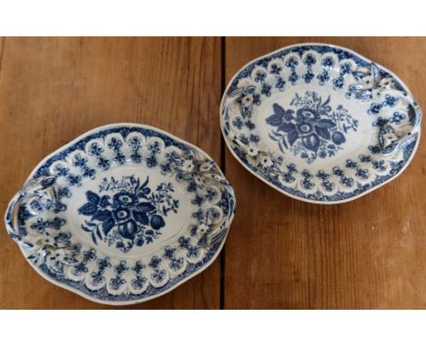 A pair of 18th century Worcester porcelain oval dishes, decorated in blue and white to a moulded ground, with twig and flower