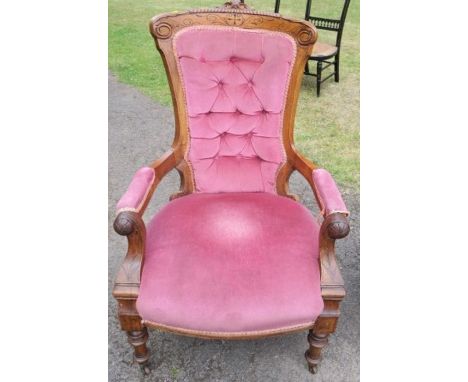 A Victorian mahogany showwood open armchair, with carved decoration and button back
